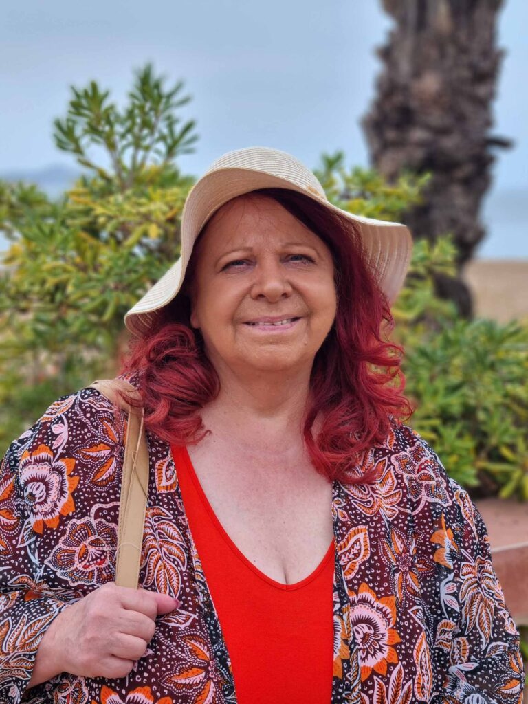 Lavinia in hat with colorful attire