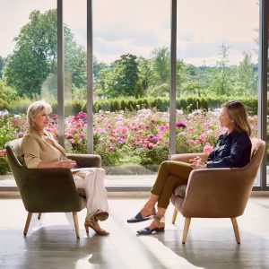 Two women sitting in a garden.